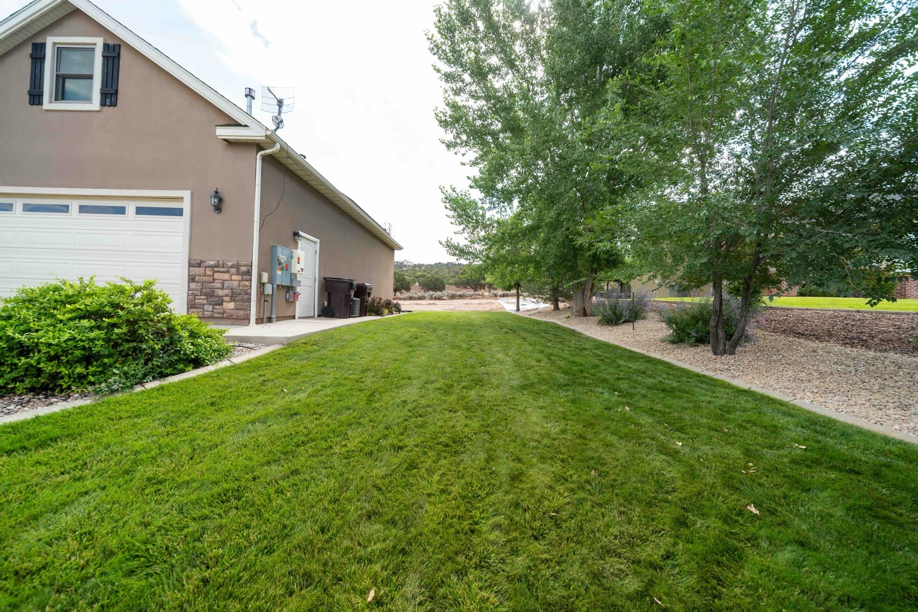 A completed Full Curl Landscaping residential project — fresh sod and clean lawn edging
