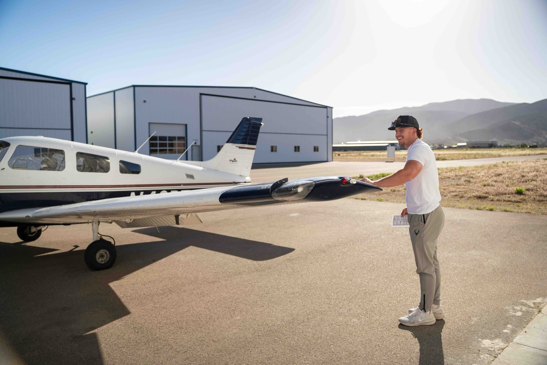 Hunter Hanshew boarding a Piper aircraft ahead of a flight instruction session
